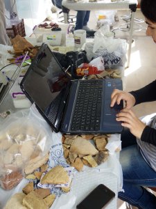 A co-worker delicately balances her laptop on pottery context [209]